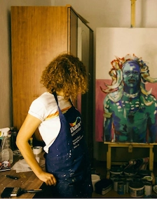 A woman painting on a canvas